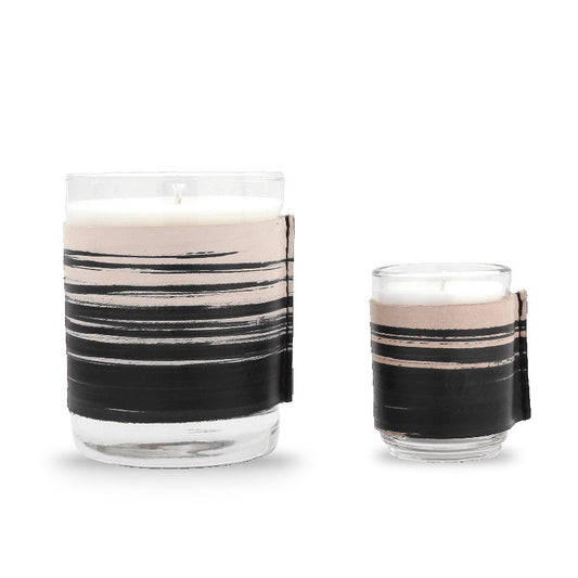 Two scented candles in glass containers with hand painted leather wraps, one large candle and one small candle