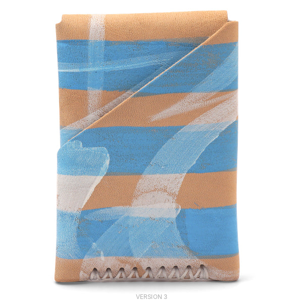 A folded leather wallet or card case with a horizontal striped pattern in tan, light blue, and white, featuring a stitched edge at the bottom, shown on a plain white background.