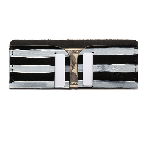 Black vegetable tanned leather wallet with white hand painted stripes open with cards and bills