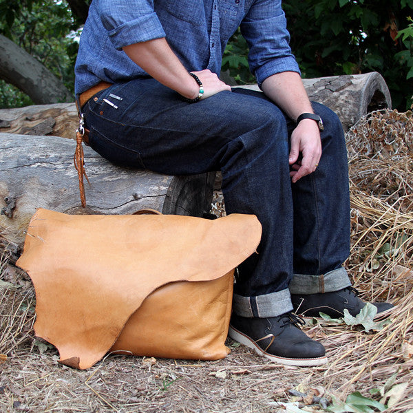 Leather messenger bag with selvedge denim and red wing boots