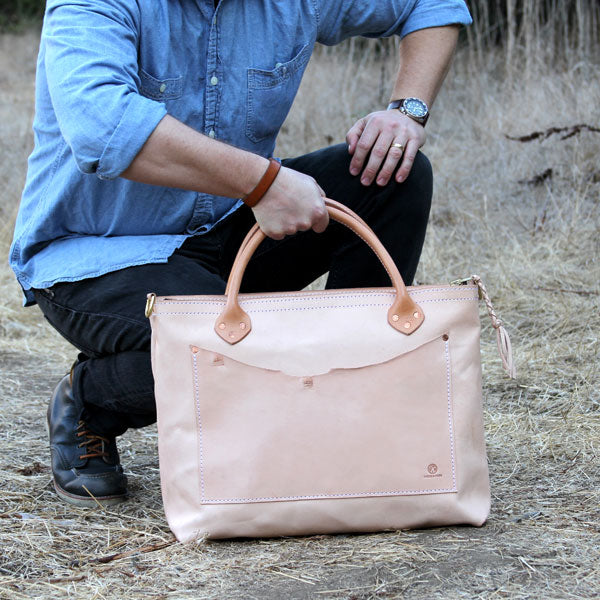 Large veg tan leather bag with denim outfit