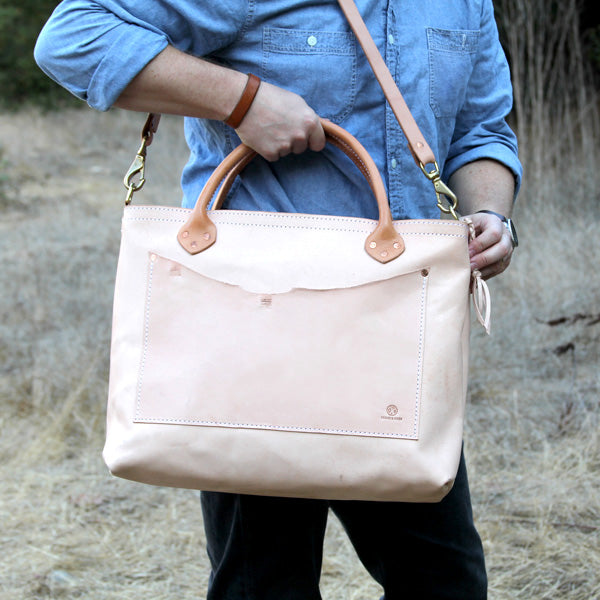 Large veg tan leather bag with shoulder strap with denim outfit